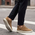 Brown men's retro suede trainers with a lace-up front and cushioned sole