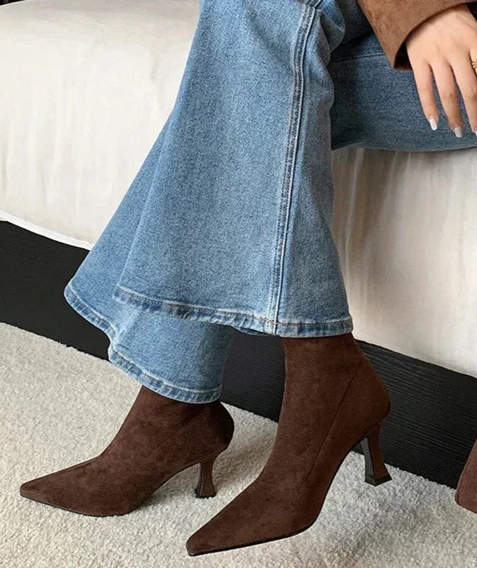Ankle boots with a block heel and pointed toe, product still life