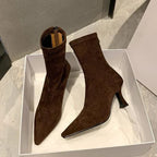 Ankle boots with a block heel and pointed toe, product still life