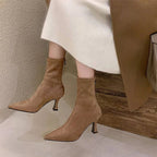Ankle boots with a block heel and pointed toe, product still life