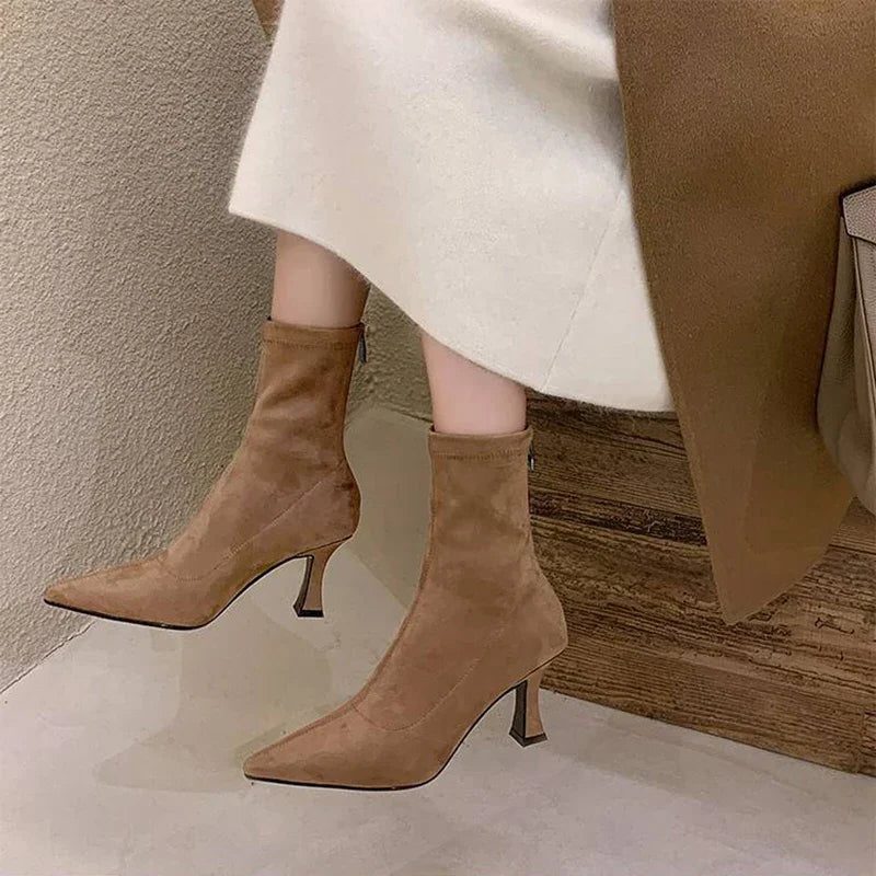 Ankle boots with a block heel and pointed toe, product still life