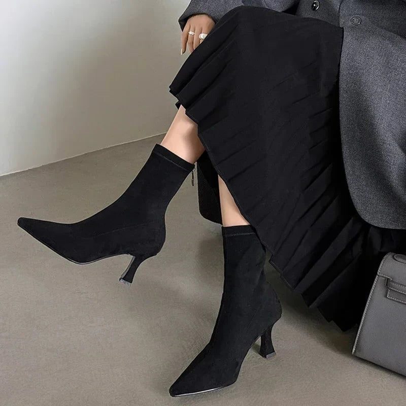 Ankle boots with a block heel and pointed toe, product still life