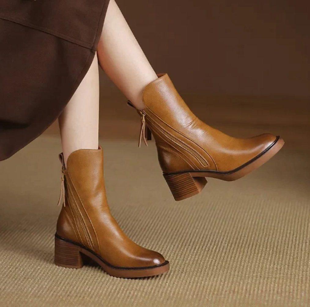 Ankle boots with a block heel and side zip fastening, product still life