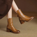 Ankle boots with a block heel and side zip fastening, product still life