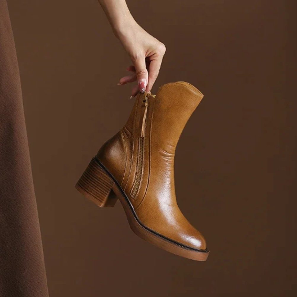 Ankle boots with a block heel and side zip fastening, product still life