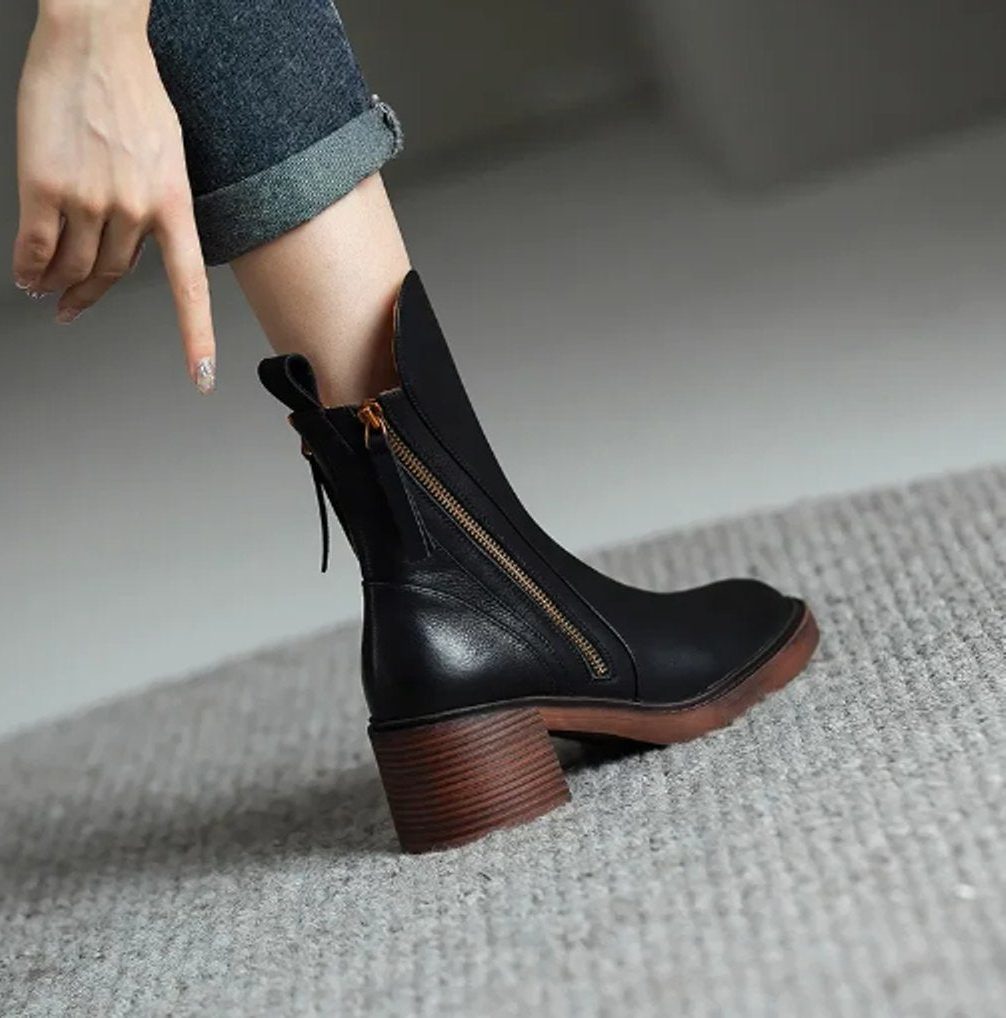 Ankle boots with a block heel and side zip fastening, product still life