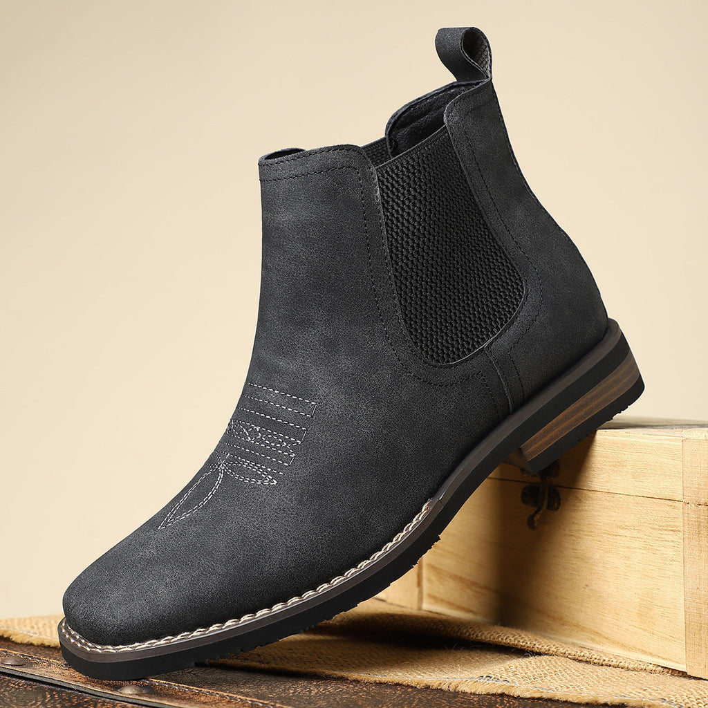 Men's leather Chelsea boots with elastic side panel, product still life