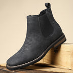 Men's leather Chelsea boots with elastic side panel, product still life