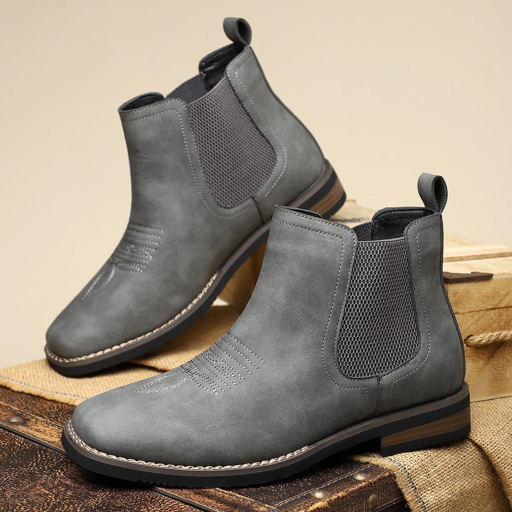 Men's leather Chelsea boots with elastic side panel, product still life
