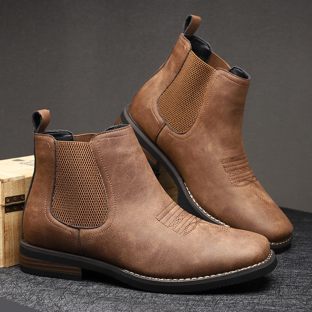 Men's leather Chelsea boots with elastic side panel, product still life