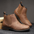 Men's leather Chelsea boots with elastic side panel, product still life