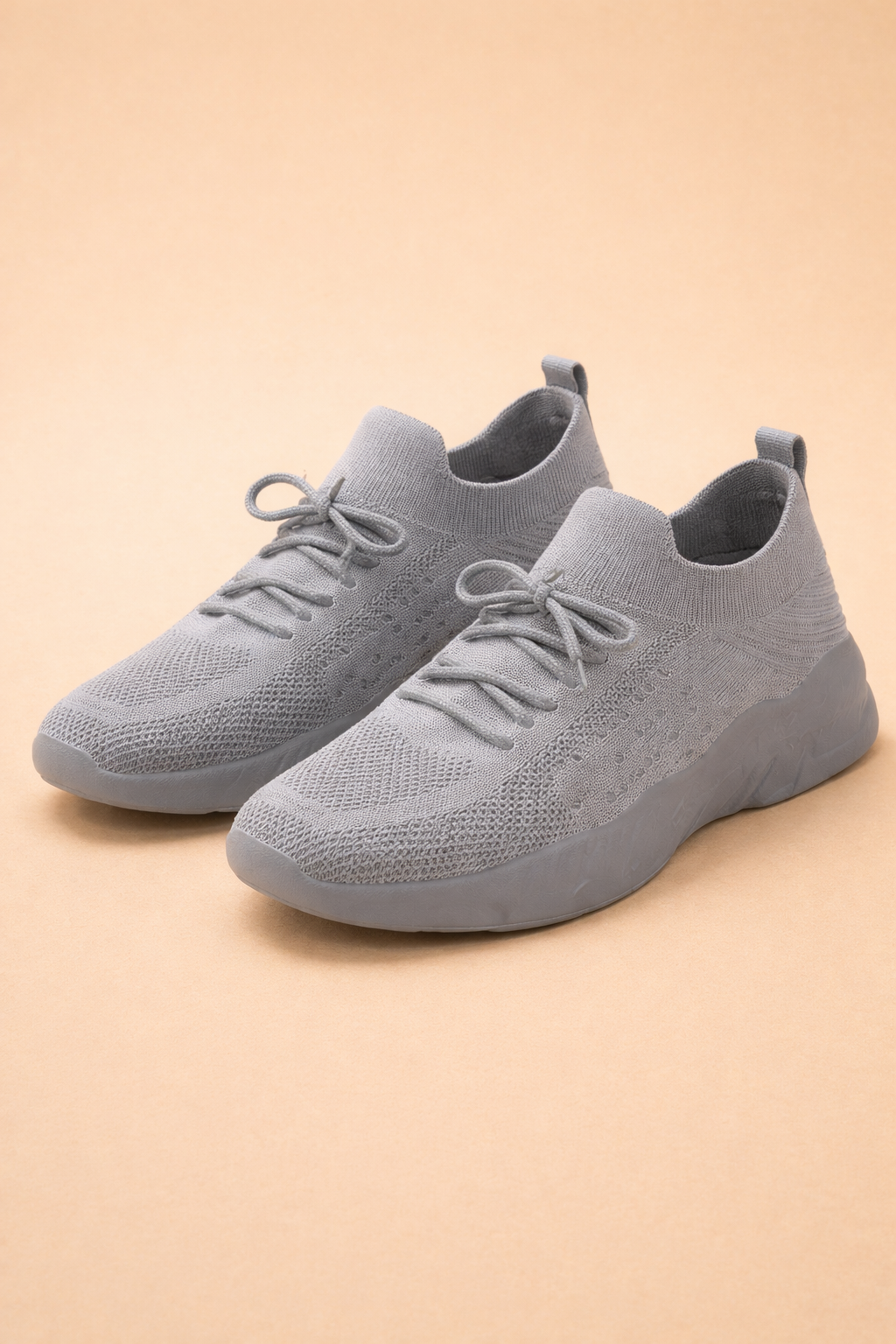 Women's red slip-on knit trainers with a cushioned rubber sole