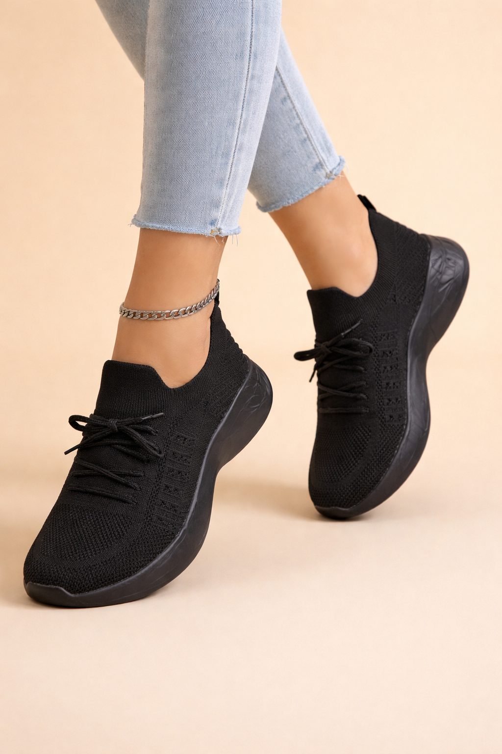 Women's red slip-on knit trainers with a cushioned rubber sole