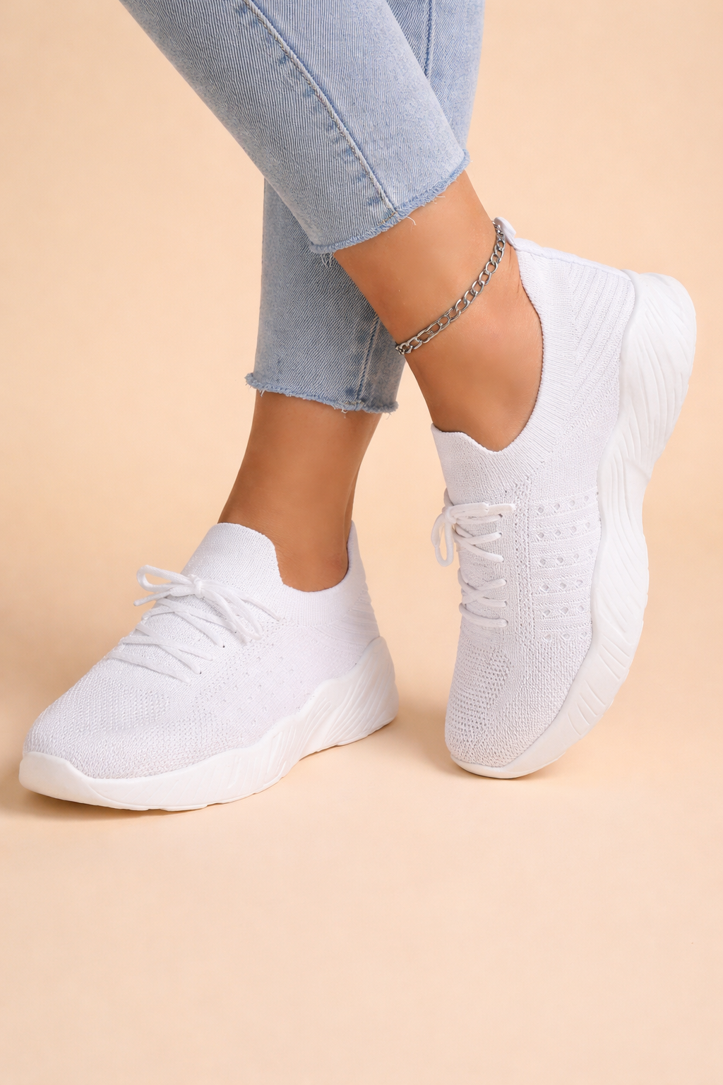 Women's red slip-on knit trainers with a cushioned rubber sole