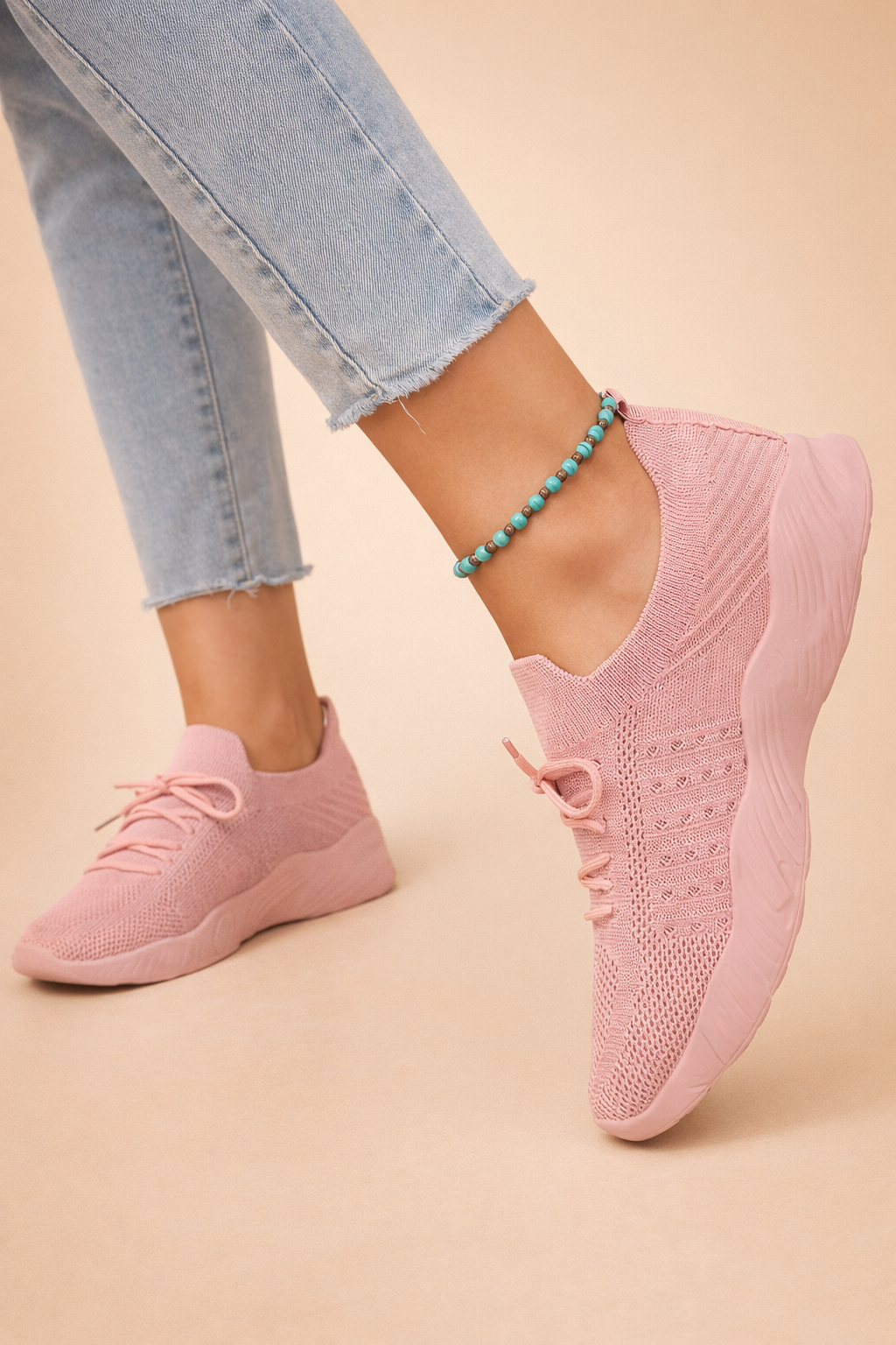 Women's red slip-on knit trainers with a cushioned rubber sole