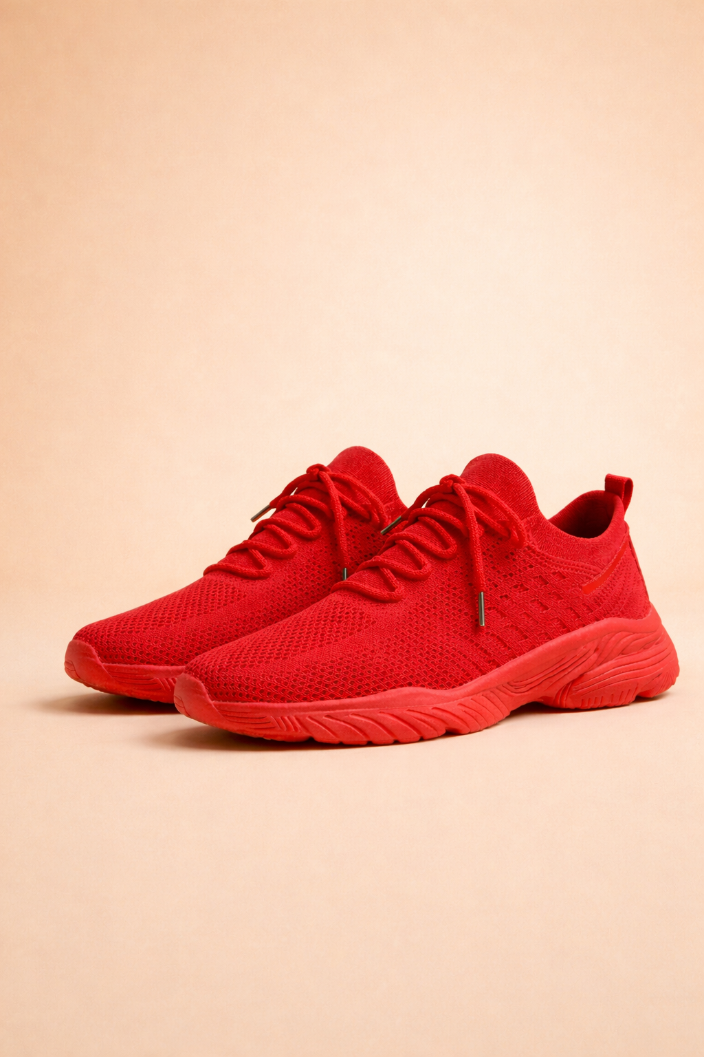 Women's red slip-on knit trainers with a cushioned rubber sole