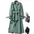 Belted long trench coat with lapel collar, product still life
