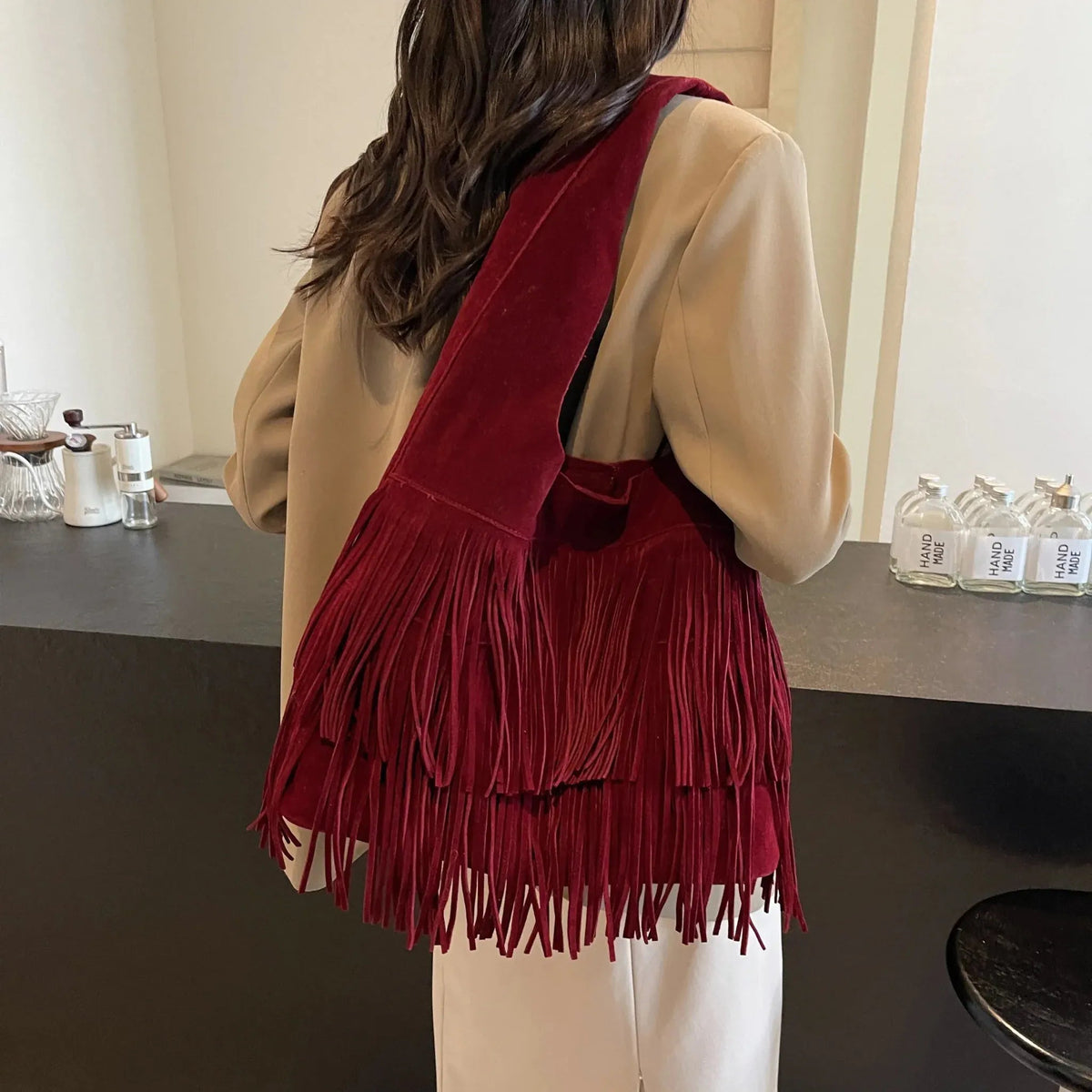 Faux suede fringe shoulder tote bag, product still life