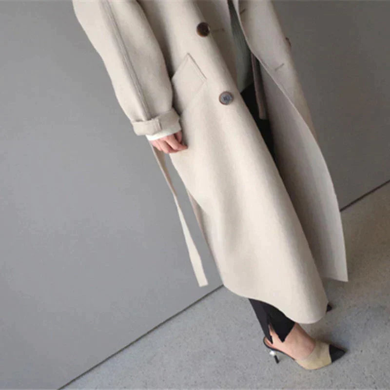 Women's beige longline wool blend coat with a tailored, elegant fit