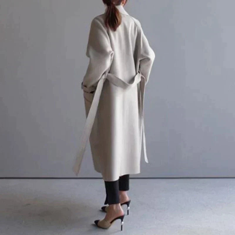 Women's beige longline wool blend coat with a tailored, elegant fit