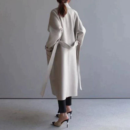 Women's beige longline wool blend coat with a tailored, elegant fit