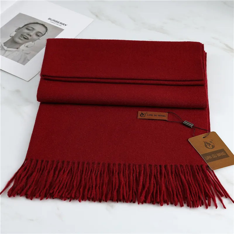 Women's burgundy cashmere scarf with soft tassel trim for autumn styling