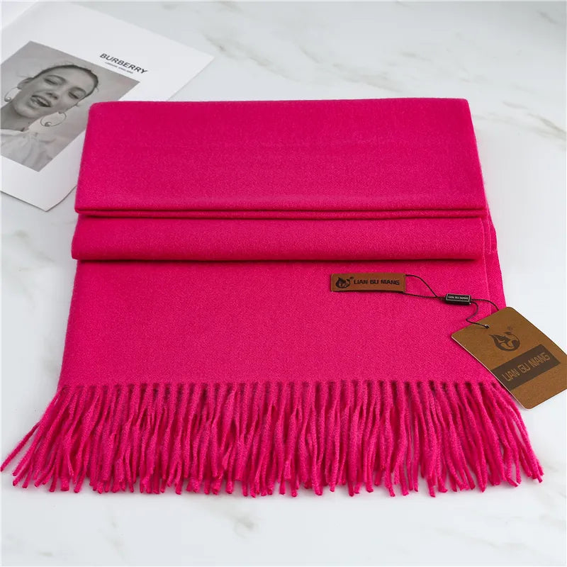 Women's bright pink cashmere scarf with soft tassel trim for autumn styling