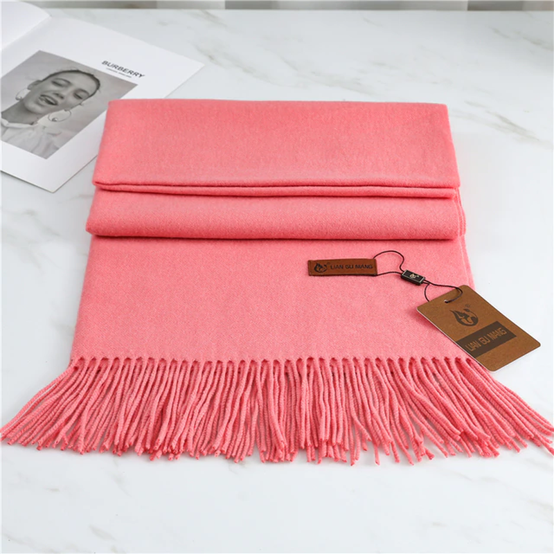 Women's pink cashmere scarf with soft tassel trim for autumn styling