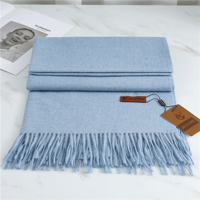 Women's sky blue cashmere scarf with soft tassel trim for autumn styling