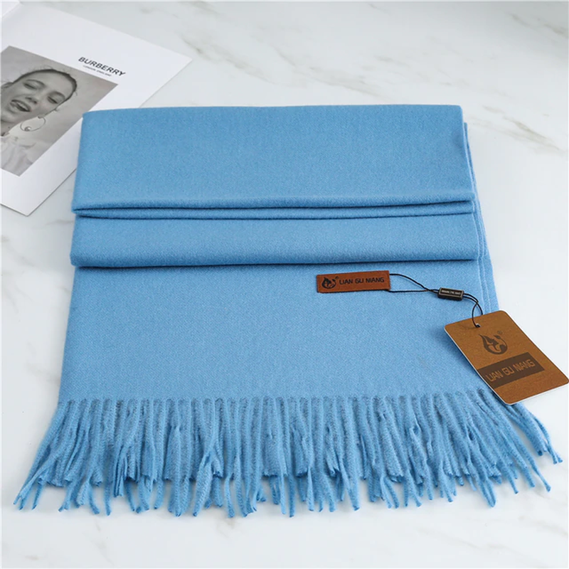 Women's blue cashmere scarf with soft tassel trim for autumn styling