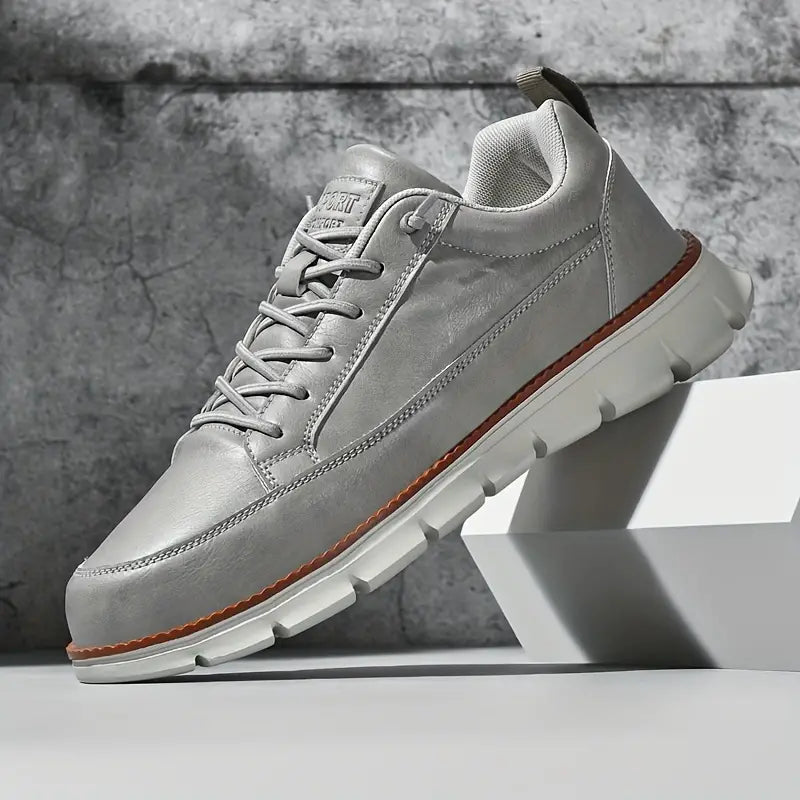 Leather trainers with supportive sole, product still life