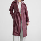 Red faux leather double-breasted trench coat with long length and tie belt