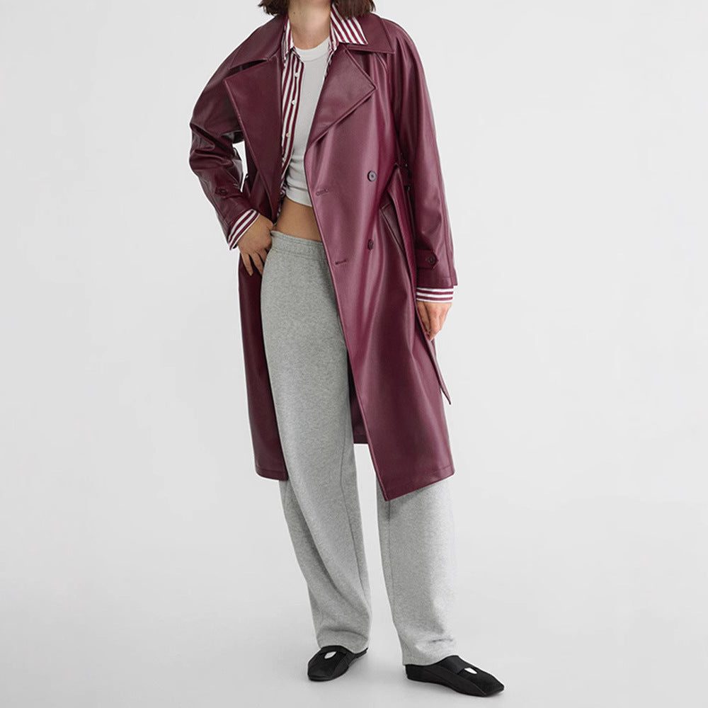 Red faux leather double-breasted trench coat with long length and tie belt