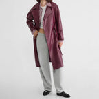 Red faux leather double-breasted trench coat with long length and tie belt