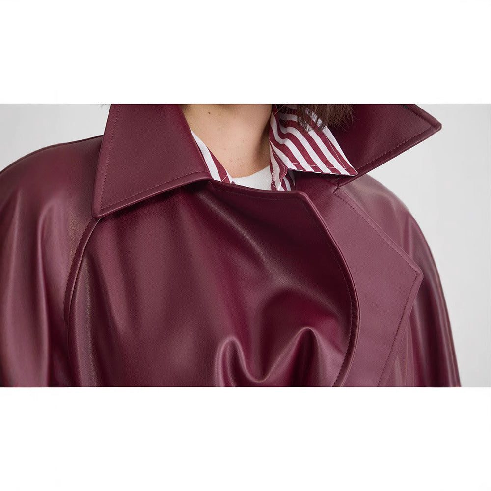 Red faux leather double-breasted trench coat with long length and tie belt