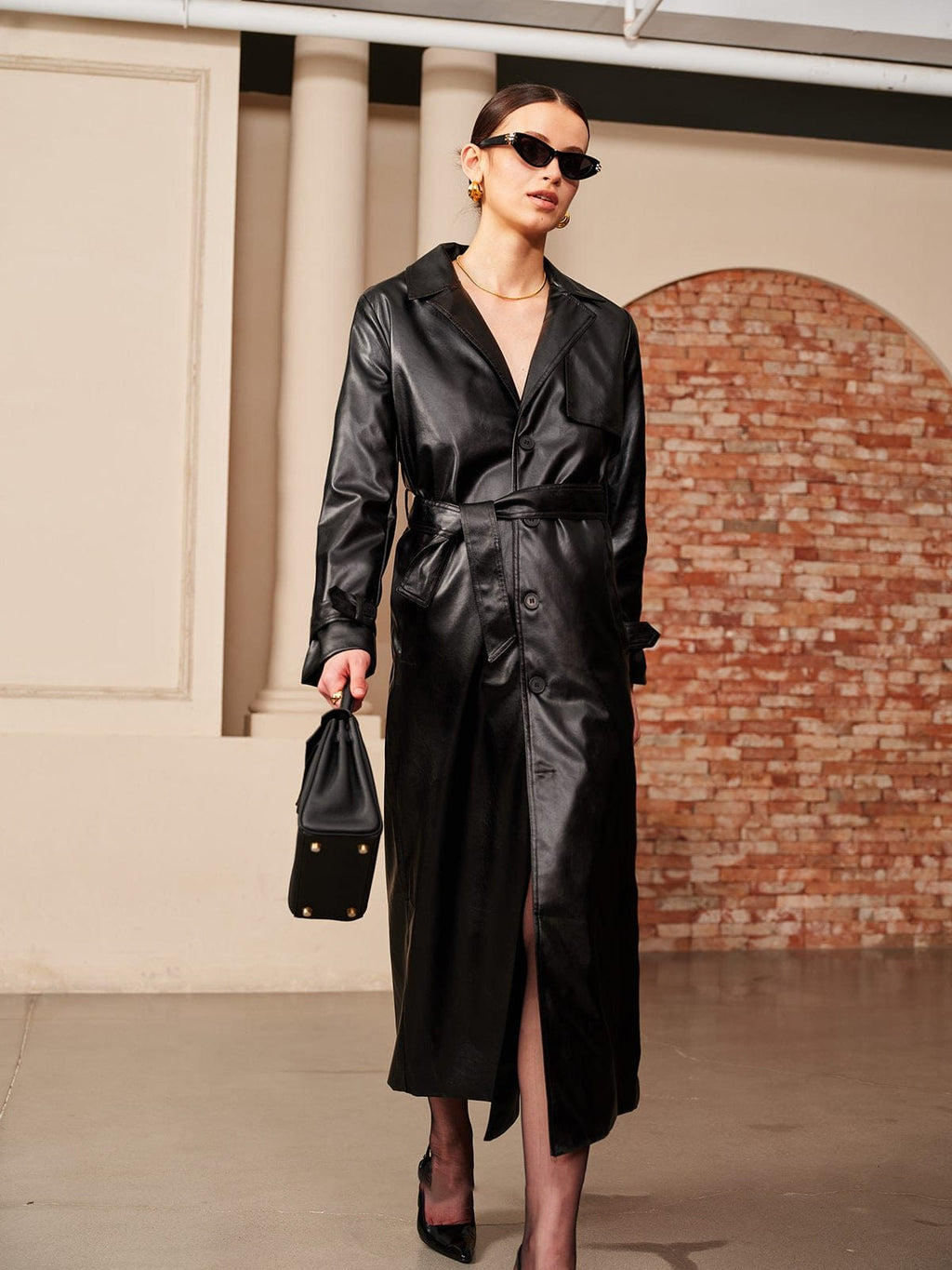Black faux leather trench coat, back view