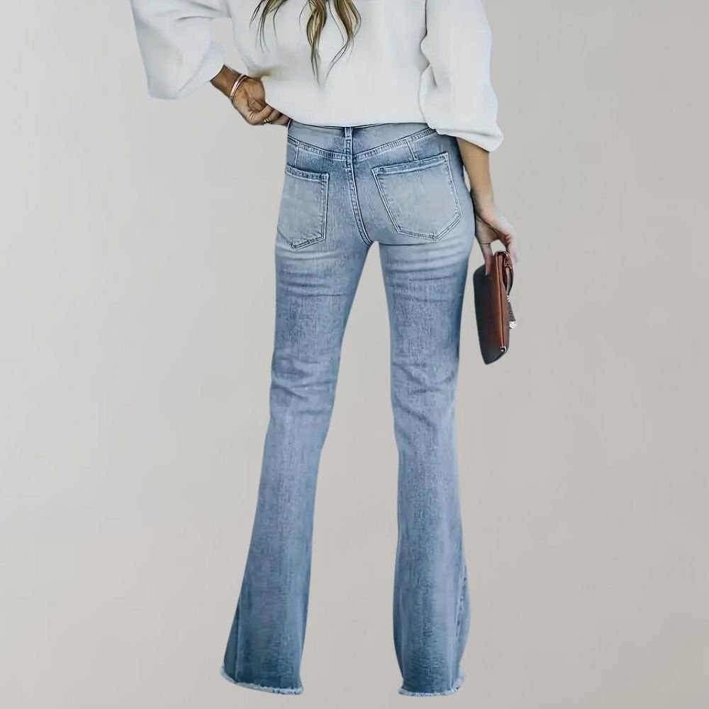 Women's high waisted flared jeans in a light wash with a frayed hem, front view