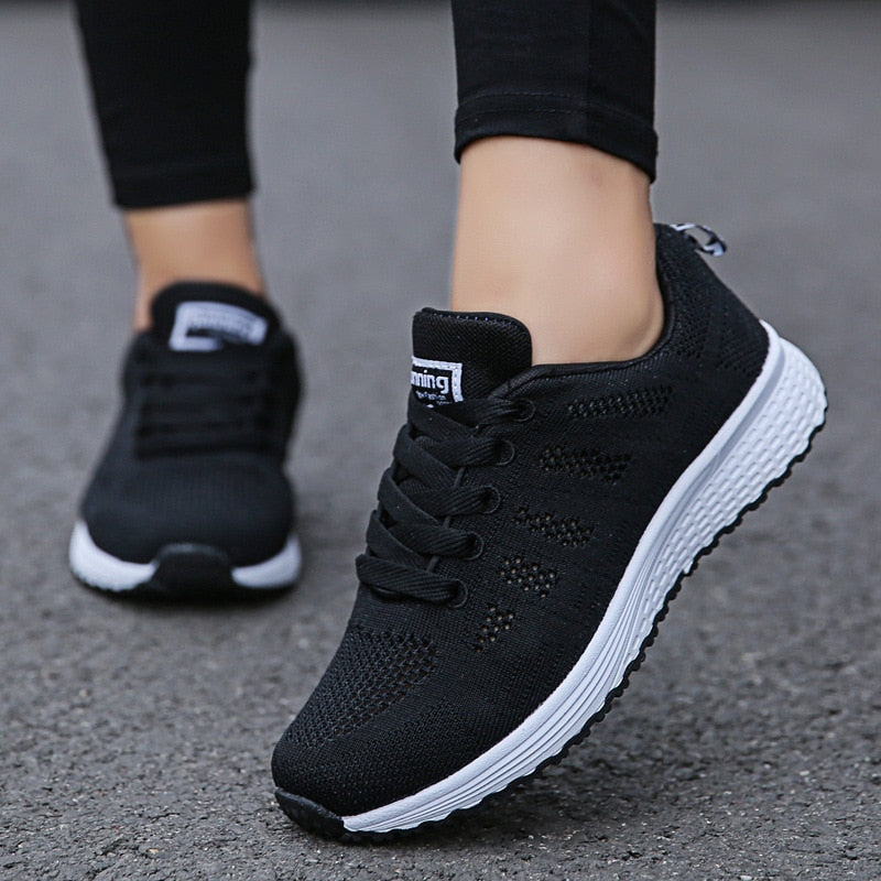 Women's black lightweight mesh walking trainers with a lace up closure
