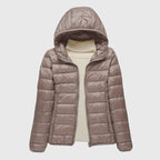 Women's dark blue quilted hooded puffer jacket with a water-resistant finish