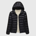 Women's dark blue quilted hooded puffer jacket with a water-resistant finish