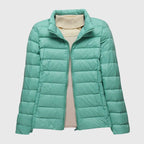 Women's dark blue quilted hooded puffer jacket with a water-resistant finish