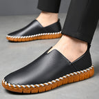 Hand-stitched leather loafers with a slip-on design, product still life