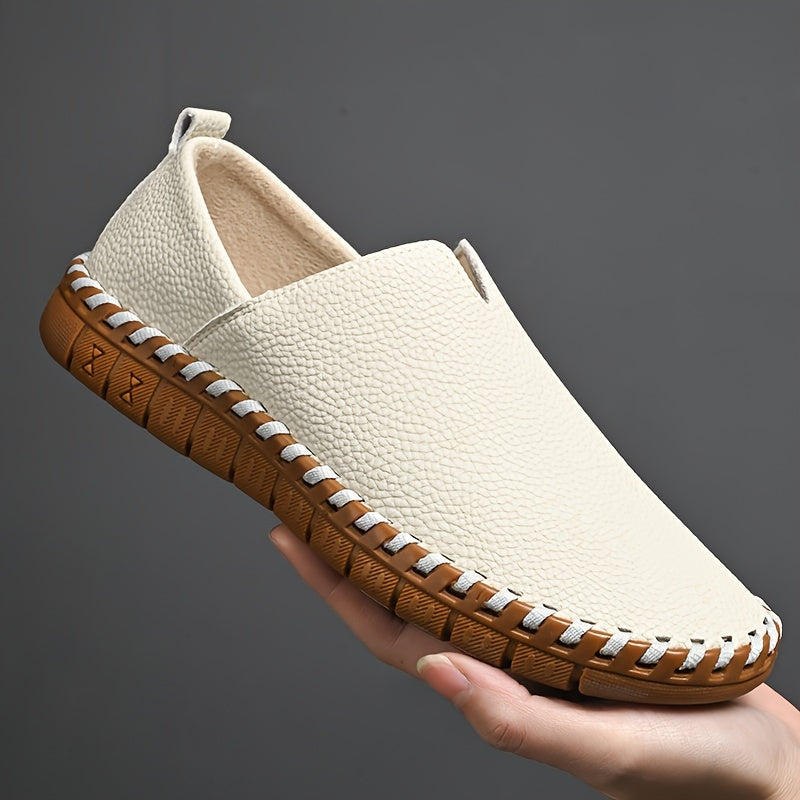 Hand-stitched leather loafers with a slip-on design, product still life