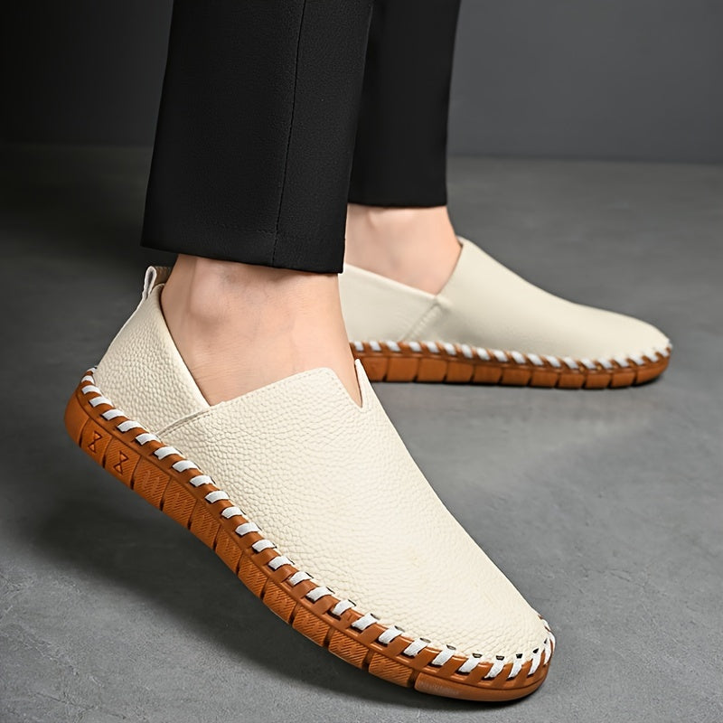 Hand-stitched leather loafers with a slip-on design, product still life
