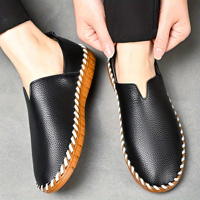 Hand-stitched leather loafers with a slip-on design, product still life