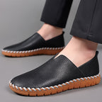 Hand-stitched leather loafers with a slip-on design, product still life
