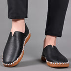 Hand-stitched leather loafers with a slip-on design, product still life