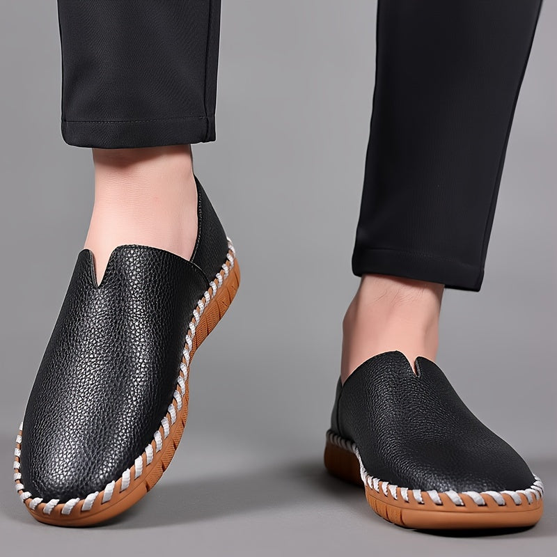 Hand-stitched leather loafers with a slip-on design, product still life