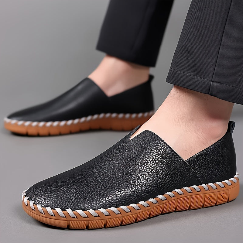 Hand-stitched leather loafers with a slip-on design, product still life