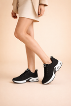 Women's black lightweight sports trainers with a breathable knit upper
